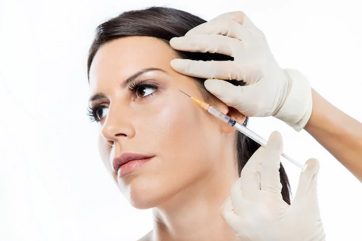 beautiful young woman getting botox cosmetic injection her face