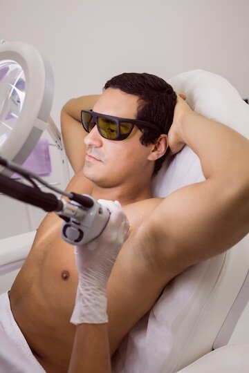 man receiving under arm laser hair removal treatment
